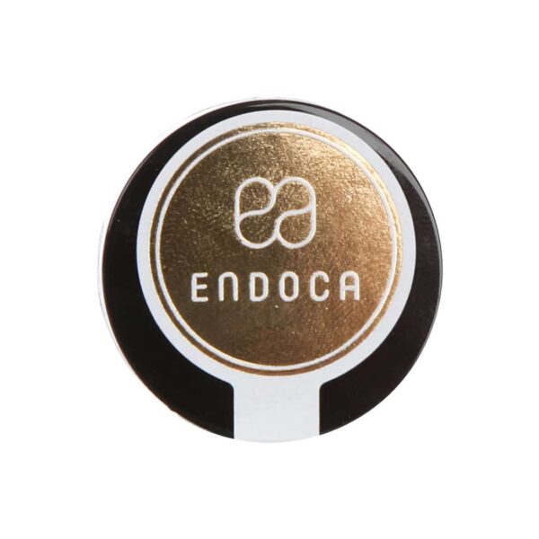 A black and gold button with the product name "Endoca CBD Crystals 98% (500mg Pure CBD)" on it.